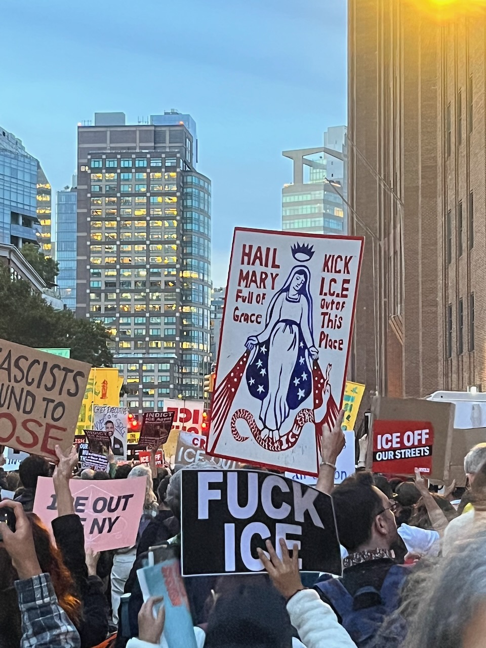 I’m in the middle of a protest march in Manhattan, behind a sign that says 'Hail Mary, Full of grace, Kick ICE out of this place'