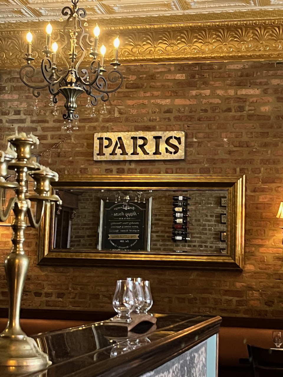 A photograph taken inside an American cafe with Parisian pretensions. It includes a metal sign with the letters of 'PARIS' cut out of it, stencil-style, except that the 'S' is quite clearly upside-down.
