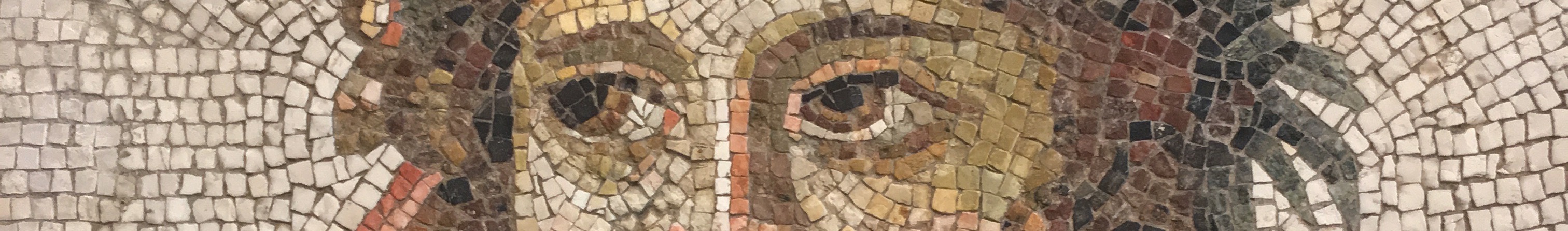 Detail of an ancient Greek mosaic portrait of a person's face, cropped to show only their eyes.
